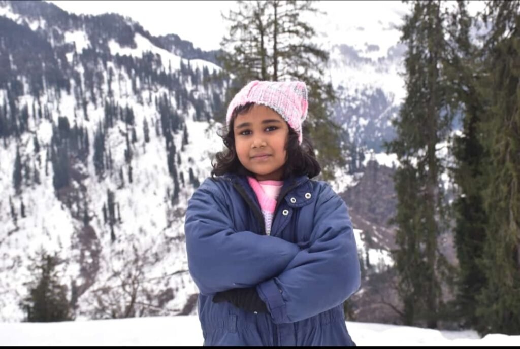 little baby is enjoying in snowfall in Kullu Manali